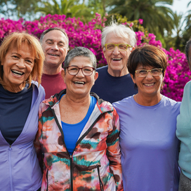 Group of 6 older adults including 2 men and 4 women smiling in fitness clothes.