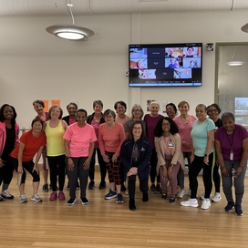 Group photo of about 20 older adult women in workout clothes.