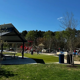 photo of a playground with a picnic pavilion in the foreground