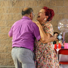 Caucasian couple dancing.