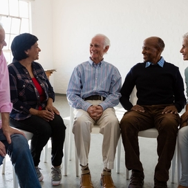 A group of people sitting together and having a conversation.