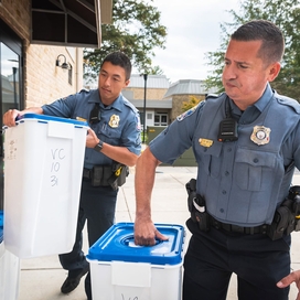 Officers lift containers filled with unwanted medications