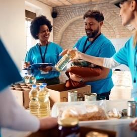 People volunteering to fill boxes with food.